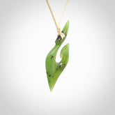 This photo shows a koru pendant carved from New Zealand Jade. The artist, Shaun Gardiner, has carved this beautifully. We provide this piece with an adjustable ice white coloured cord. This is a fantastic work of art, we have one only.